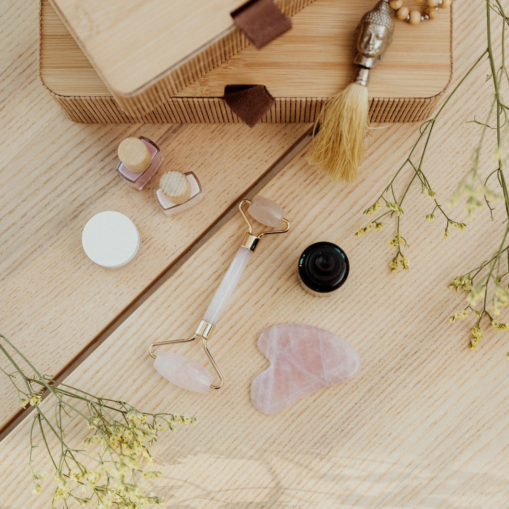 Gua sha stone and face oil beauty still life