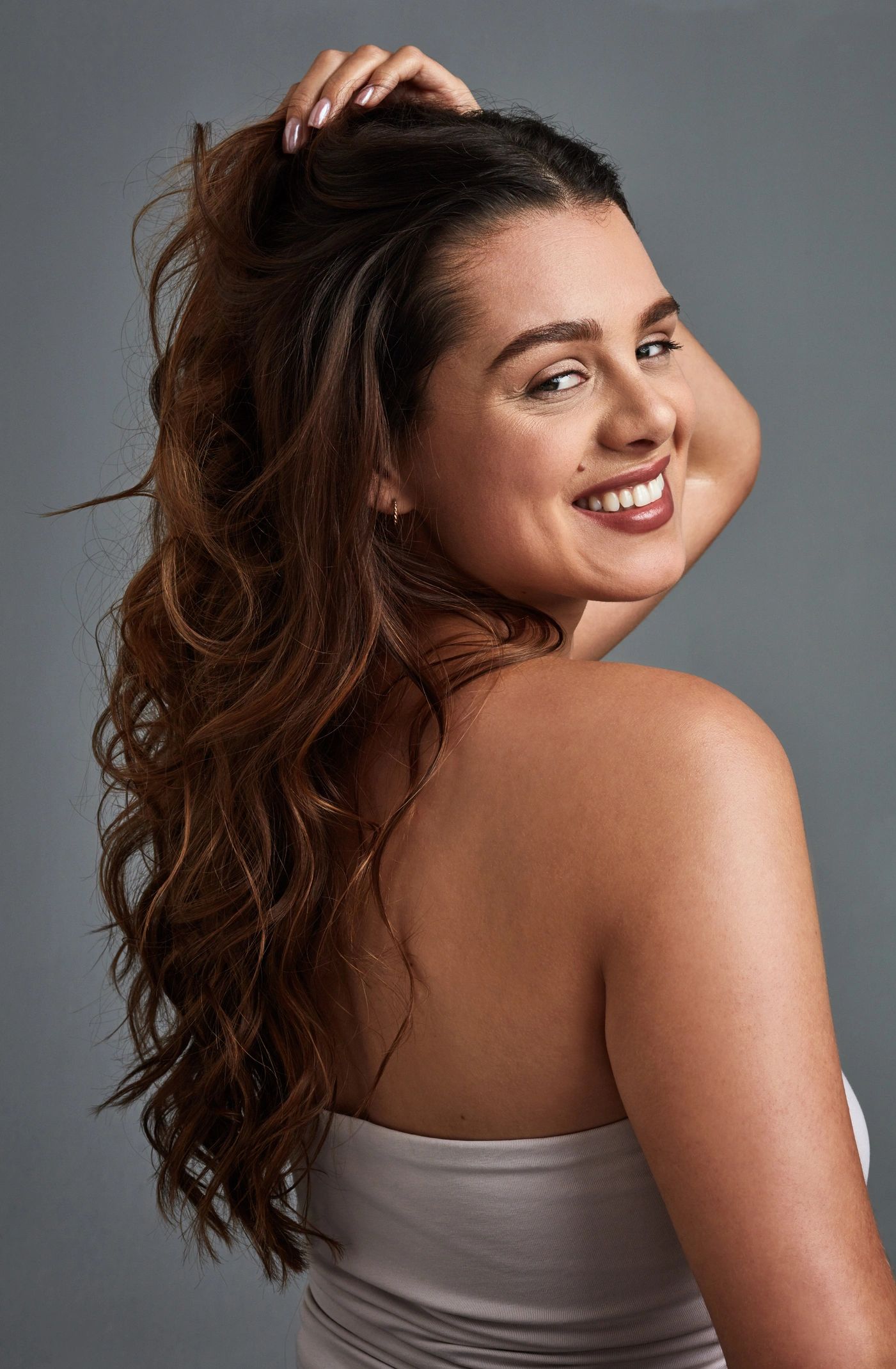 Smiling woman with long hair in a beauty portrait